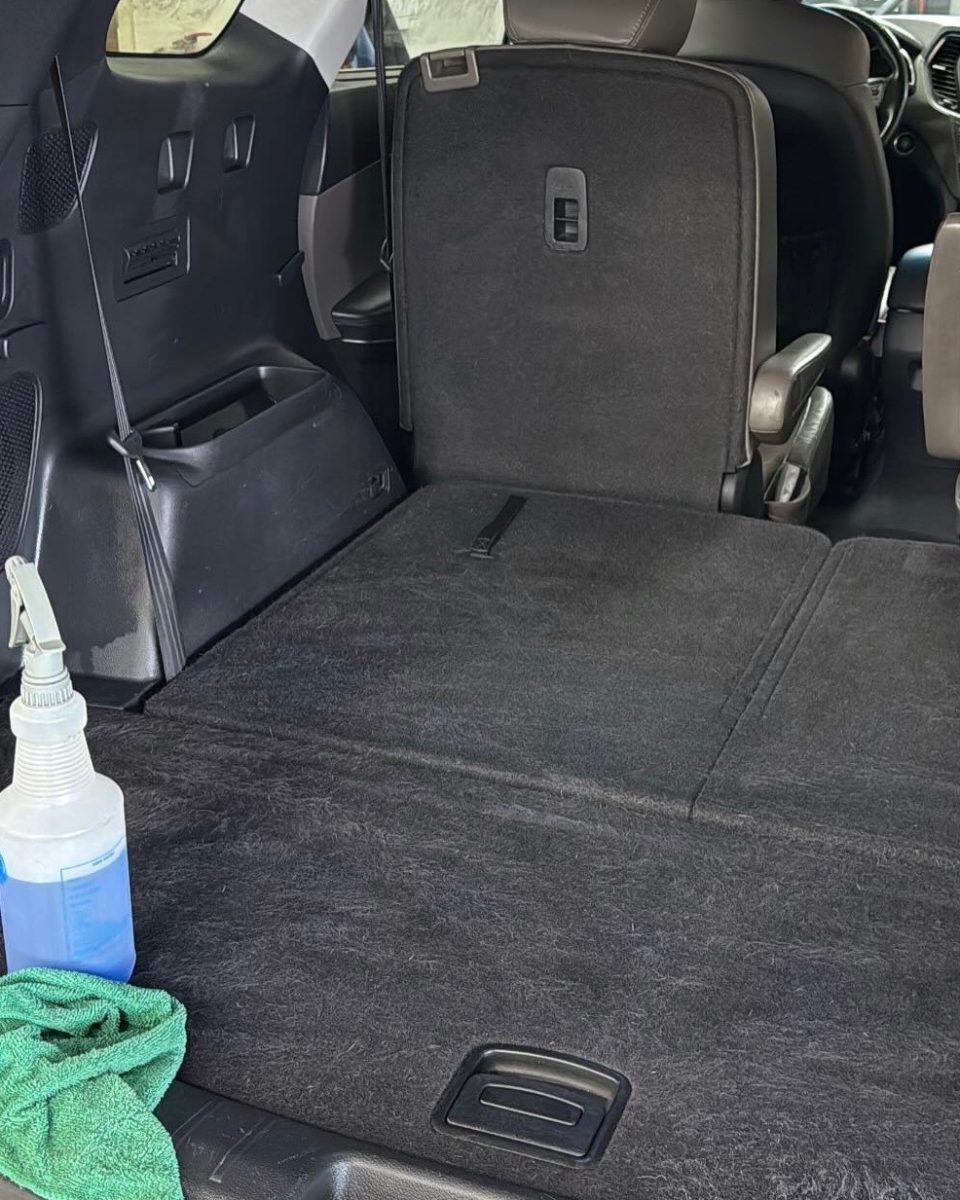 Same SUV cargo area after pet hair removal, carpet clean and even