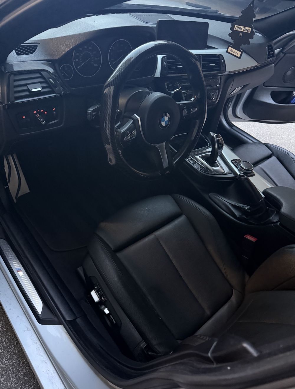 Driver seat and floor of the same BMW 4 Series after detailing