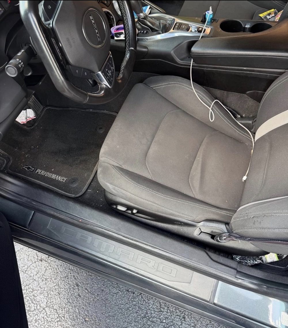 Chevrolet Camaro driver seat and floor with dirt and debris before detailing