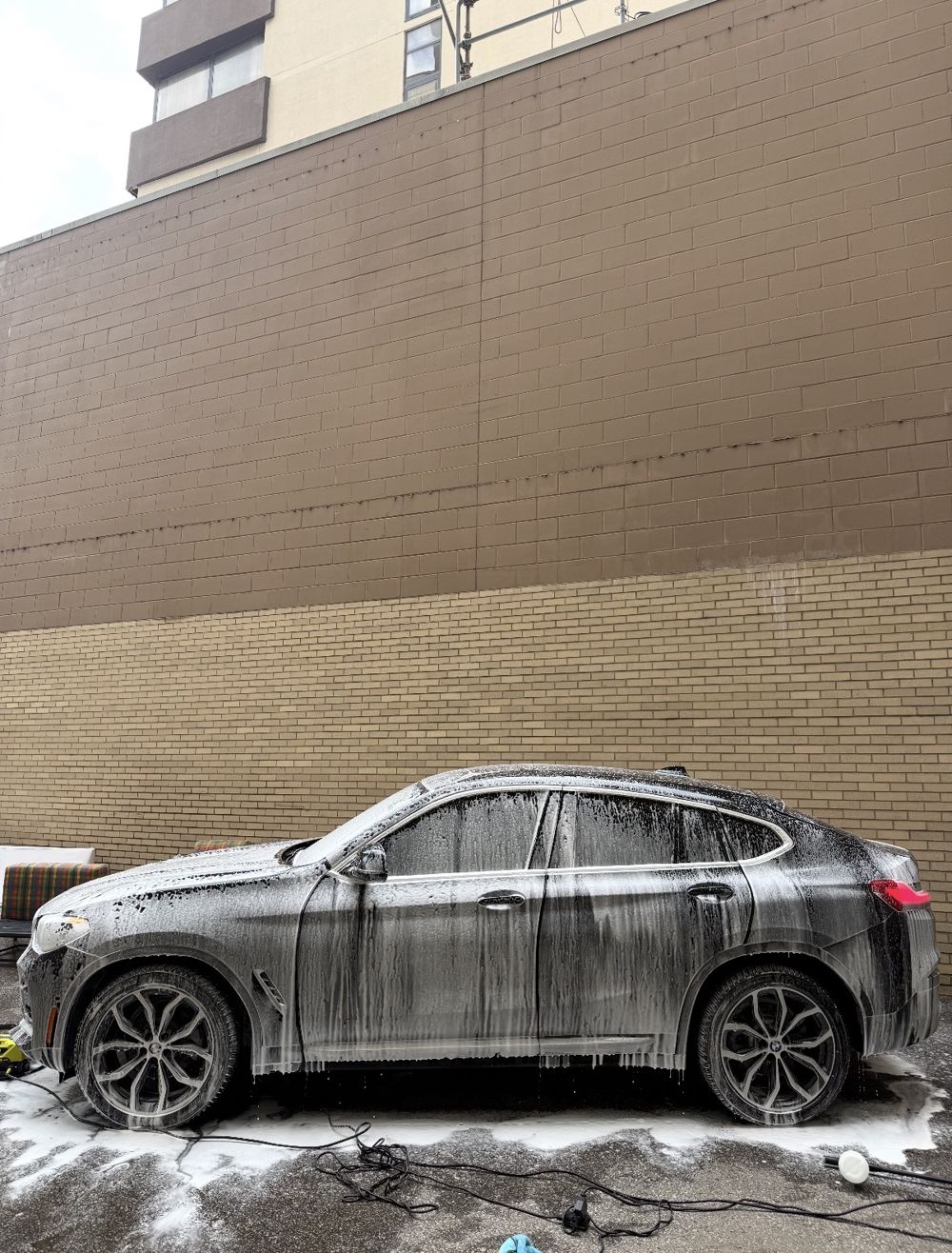 BMW X4 covered in foam during an exterior wash